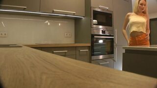 Long hair long legs hot blonde college girl on high heels and a miniskirt which does not cover her ass in the kitchen