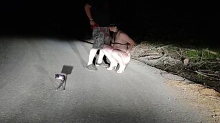 On public road total naked whore on leash and high heels pissing while sucking husband′s cock